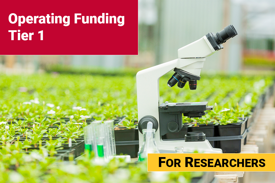 Microscope on a table surrounded by flats of plants with a red text box in the top corner that says Operating Funding Tier 1.