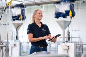 Dr. Terri O'Sullivan stands in the Ontario Swine Research Centre with a clipboard