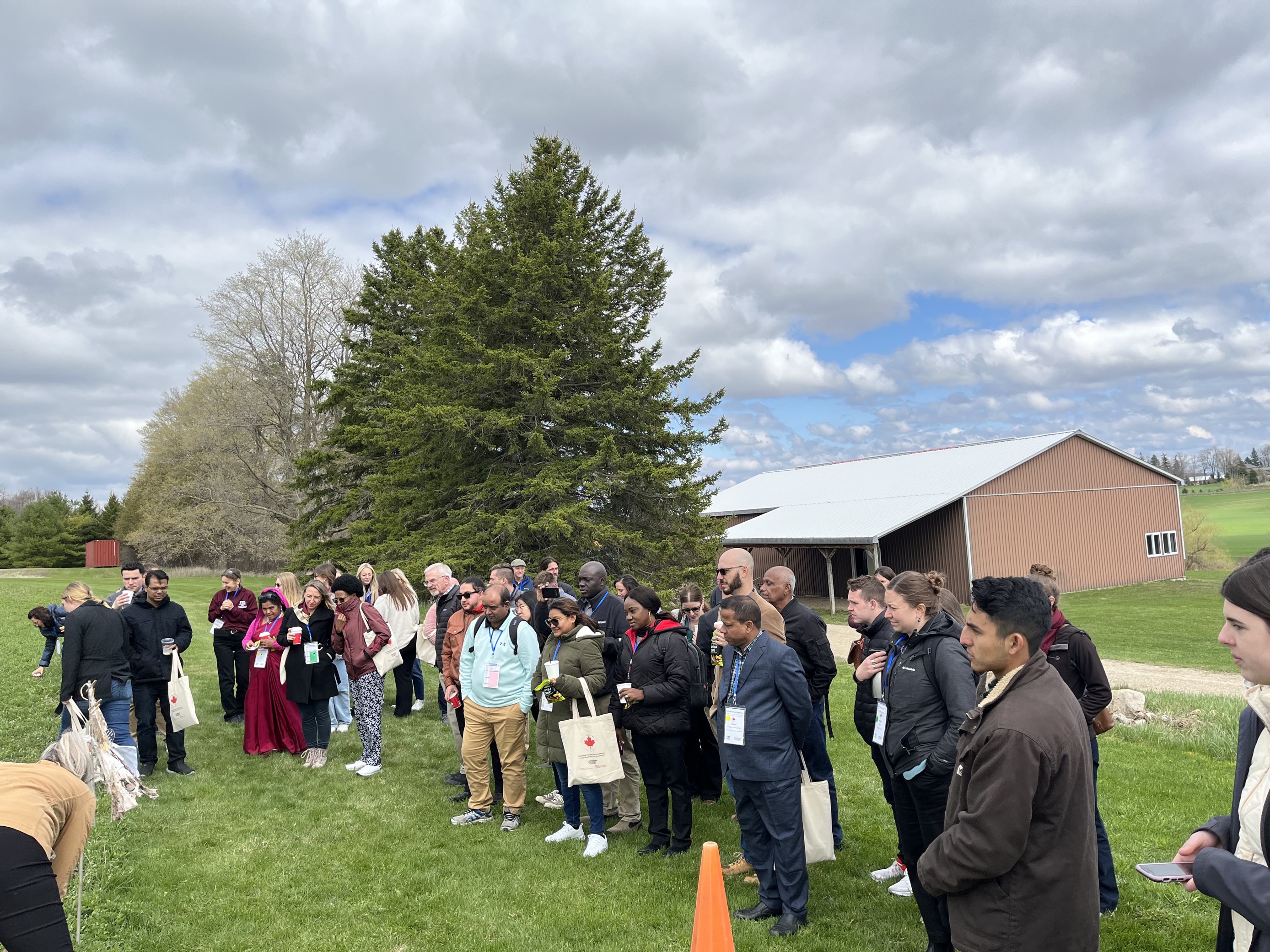 AIAEE participants stand outside in a group at the Ontario Crops Research Centre in Elora.