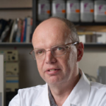 Image of Keith Warriner wearing glasses and a lab coat