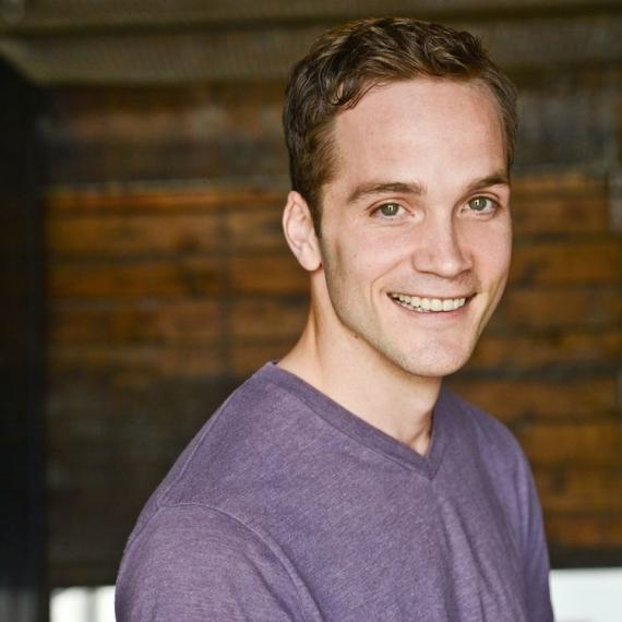 a picture of robert allan wearing a purple t-shirt