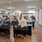 Members of the public view the exhibit