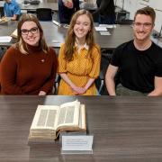 Student curators with manuscript