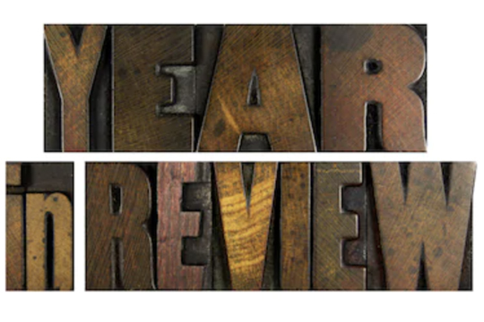 Year in Review spelled in old typesetting letters.