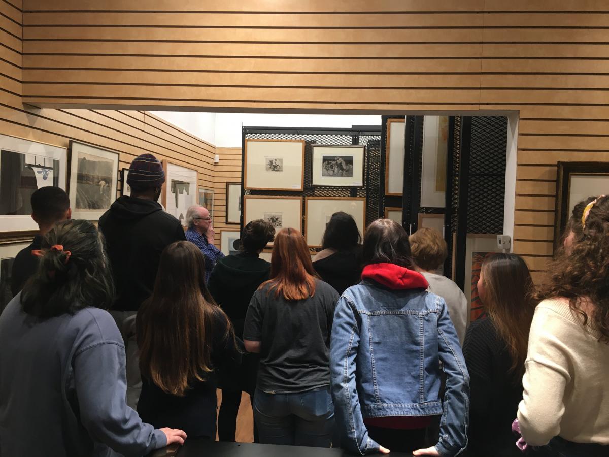 Students examining fine art prints in the collection