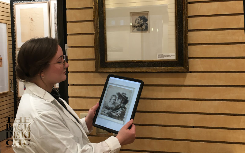 Students examining fine art prints in the collection