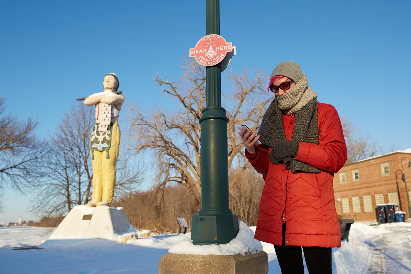 Picture of Ariel Beaujot standing in front of an Indian statue.