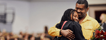 A University of Guelph student hugging her dad at her graduation ceremony