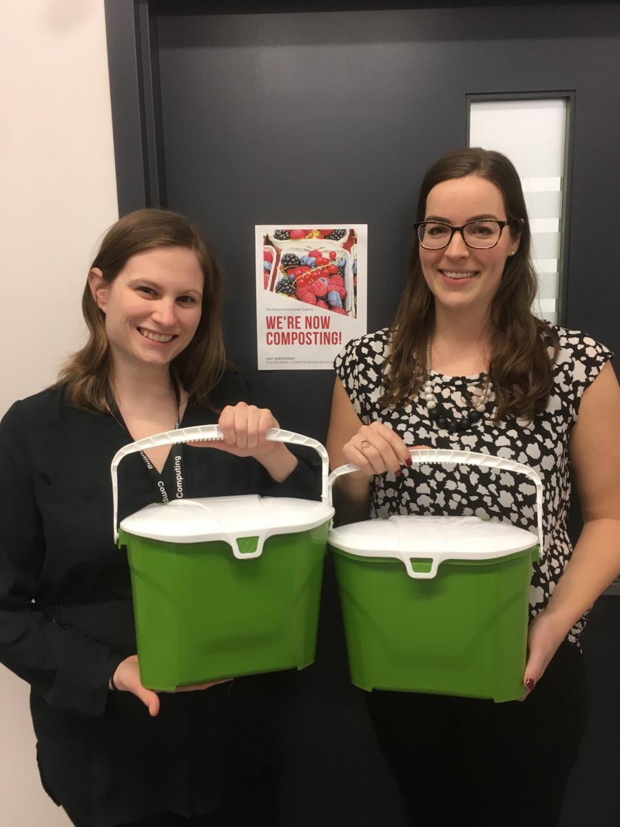 two UofG staff pose with office compost bins