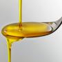 oil pouring onto spoon