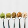 Spoons of different types of protein powder