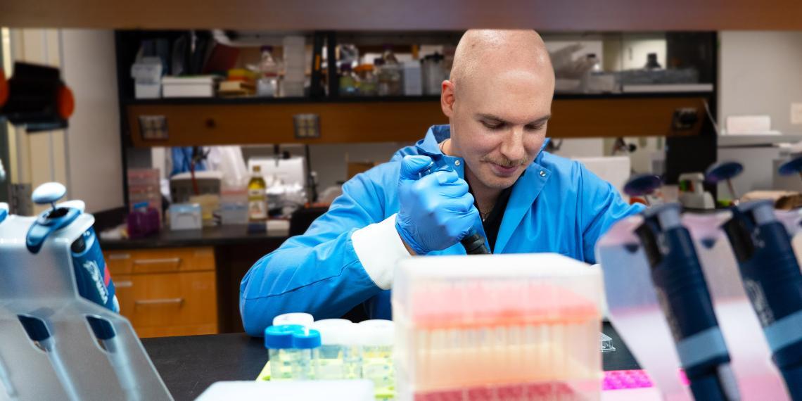 Colin Guth works at a lab bench