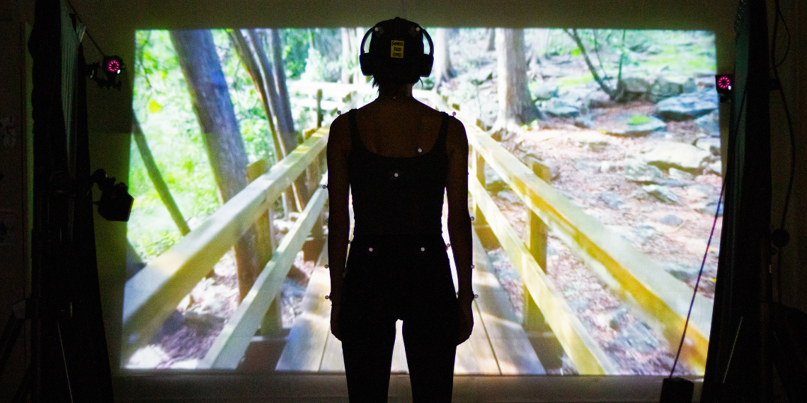 Research participant in front of a screen showing a boardwalk