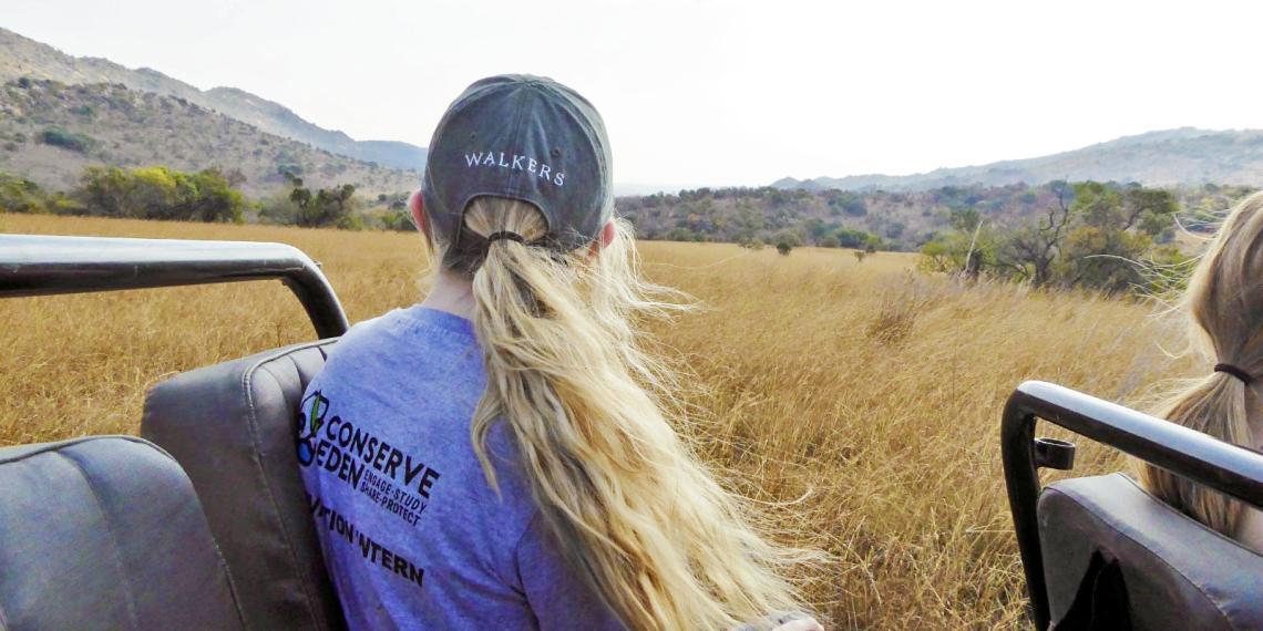 Jenn Smith sits in the back of a jeep in South Africa