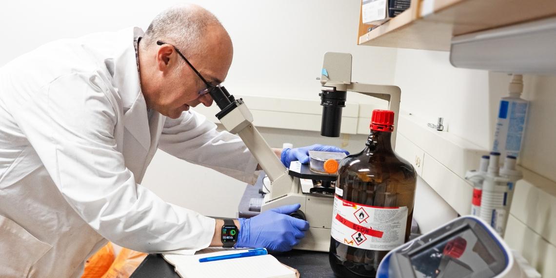 John Dawson looks through a microscope