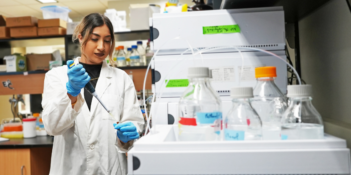 Simran Kaur next to a chromatographer