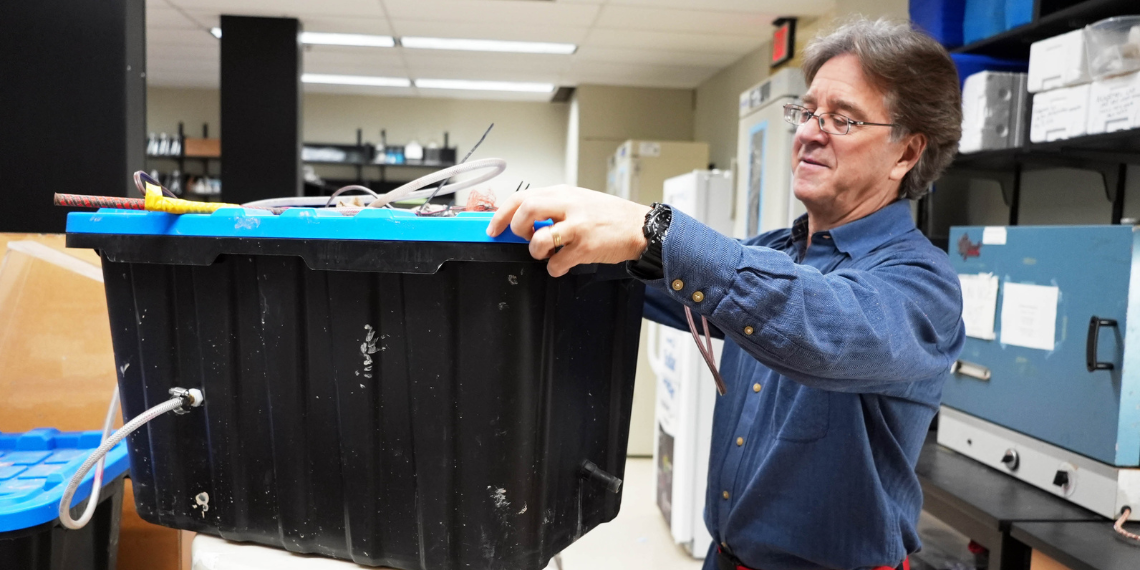 Dr. Josef Ackerman holds his rosette sampler device