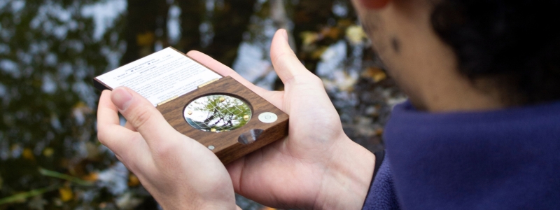 Student using device to measure tree cover