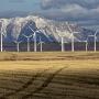 Wind farm on a field by mountains