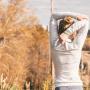 Back of a women stretching her arms and back