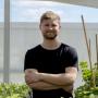 PhD student Michal Pyc in the Phytotron (photo by K. White)