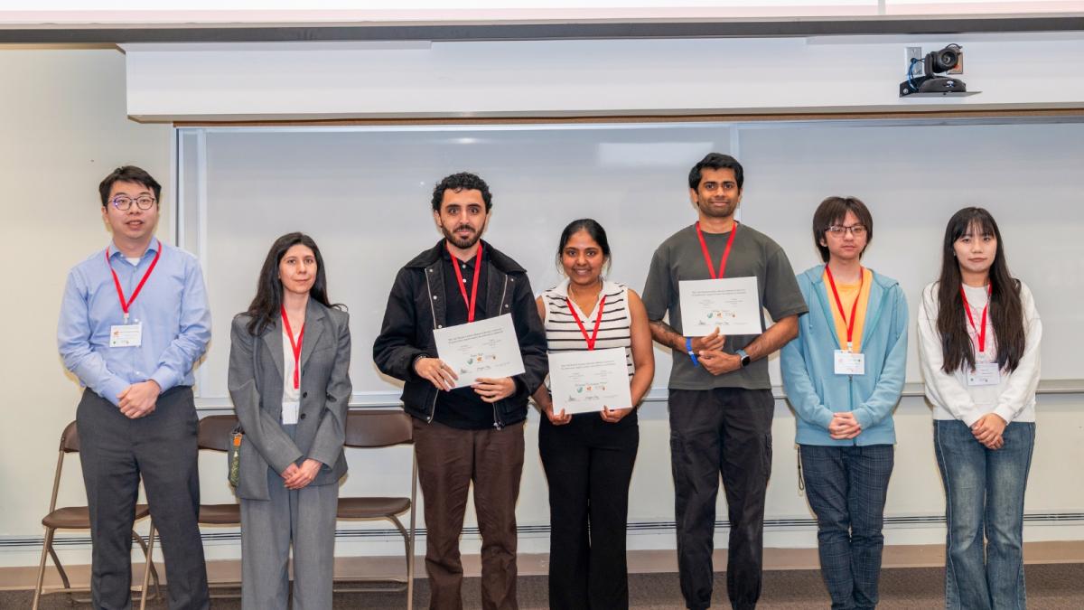Seven students standing and smiling for a photo.