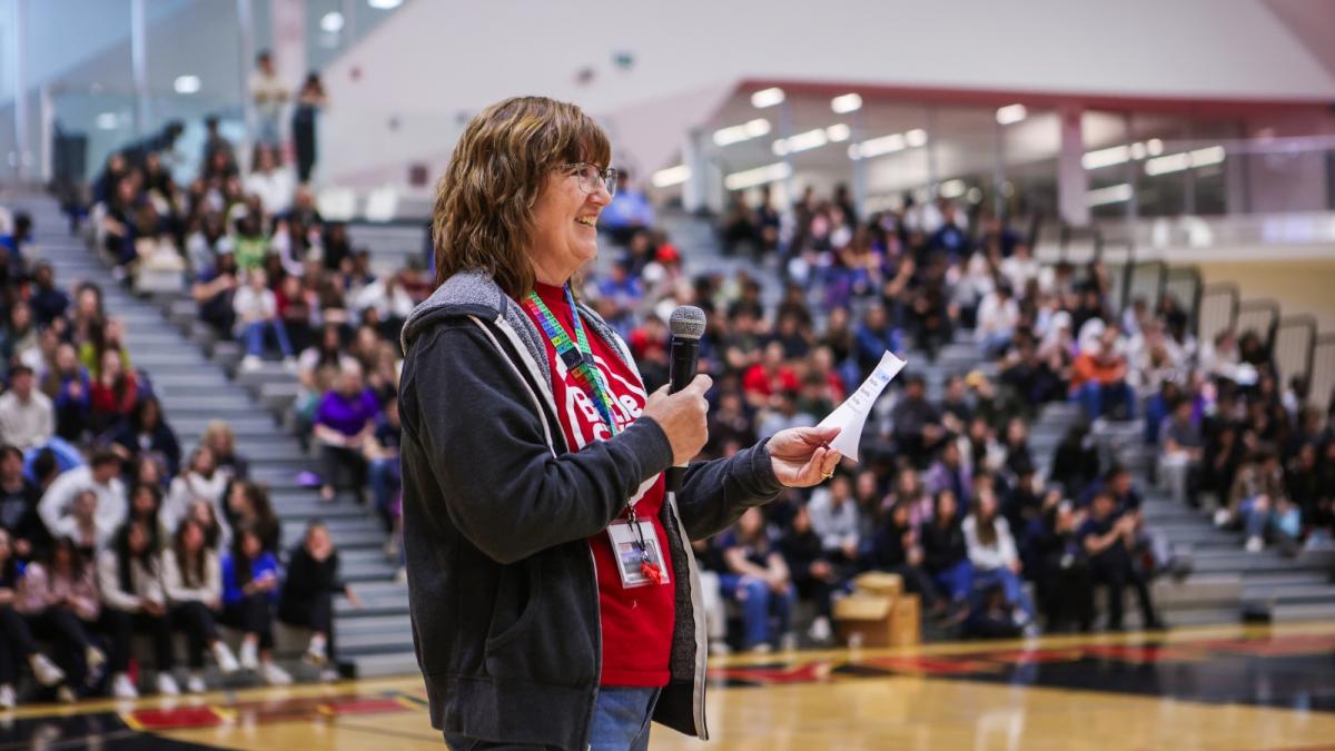 Bonnie Lasby speaking into a microphone.