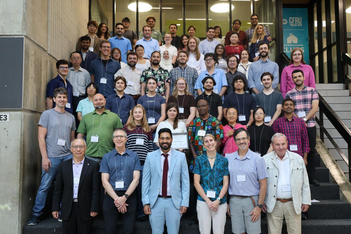 A group of people standing together and smiling.