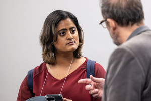 A master's student is talking to another event attendee.