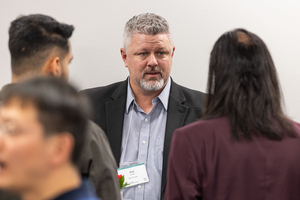 Two event attendees talking to each other.