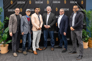 Six people at the event standing together in front of a University of Guelph backdrop.