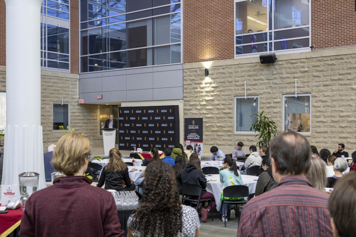 Provost and vice-president academic Dr. Bill Rosehart speaks to CCMPS launch attendees in a large atrium.