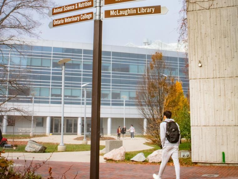 Summerlee Science Complex in the fall with a student walking.