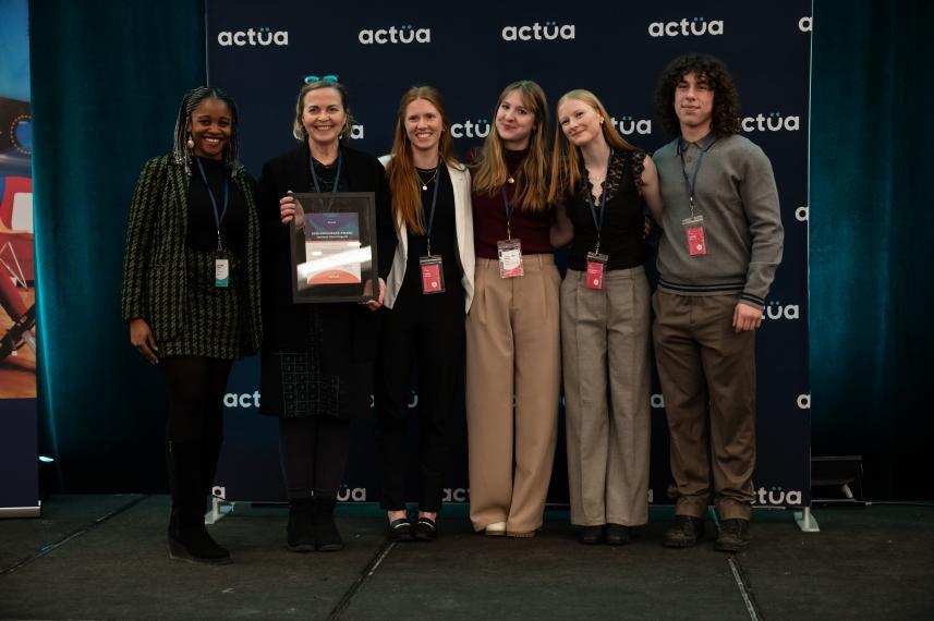 Six people posing for a photo and smiling.