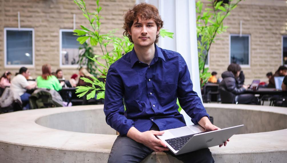 John Brennan holding a laptop.