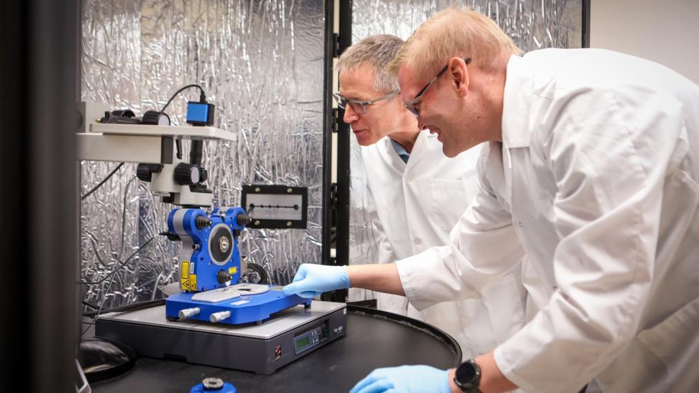 Postdoctoral scholar Dr. Benjamin Baylis, alongside Dr. John Dutcher in the physics lab.