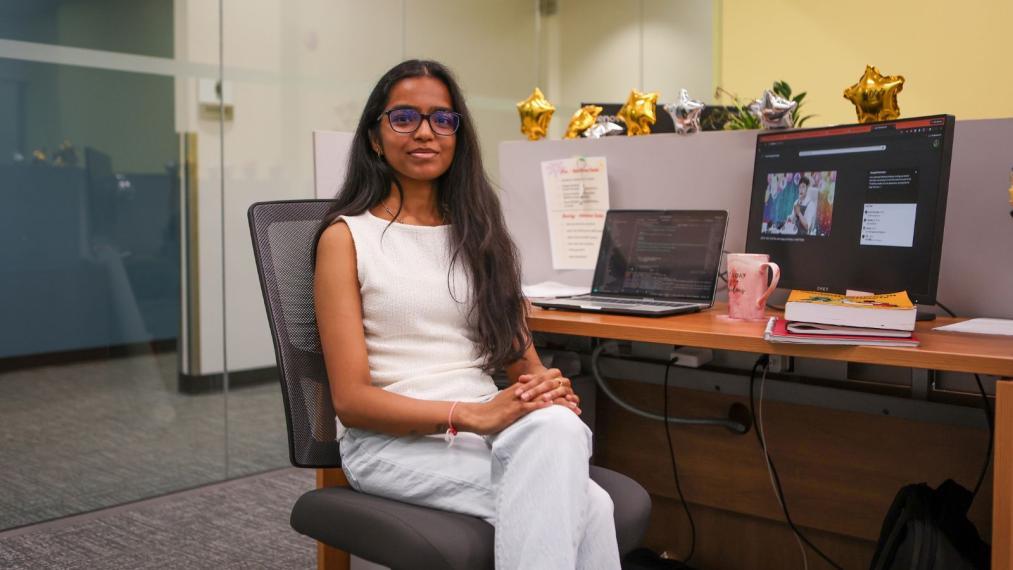Mahek Patel, seated at her work desk.