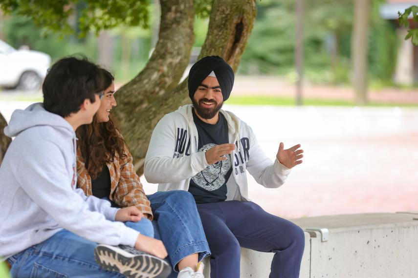 Smaranjeet chats outside at Branion Plaza with two friends.