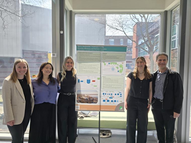 Josie Murray, Chloe Lin, Katrina Shields, Tess Muller, and Dr. Bassim Abbassi standing with a research poster.
