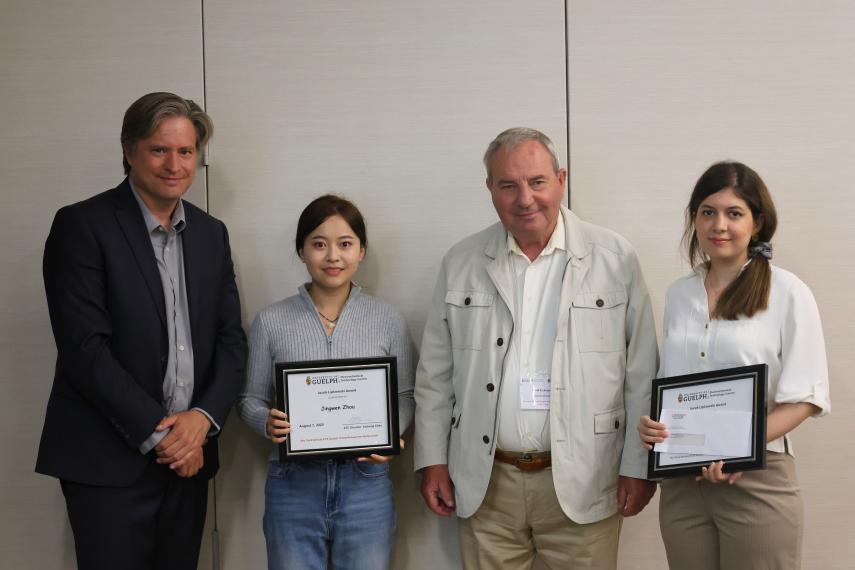 Provost and Vice-President (Academic) Dr. Bill Rosehart, Jingwen Zhou, Dr. Jacek Lipkowski and Negar Sabouhanian standing together with the two awards.