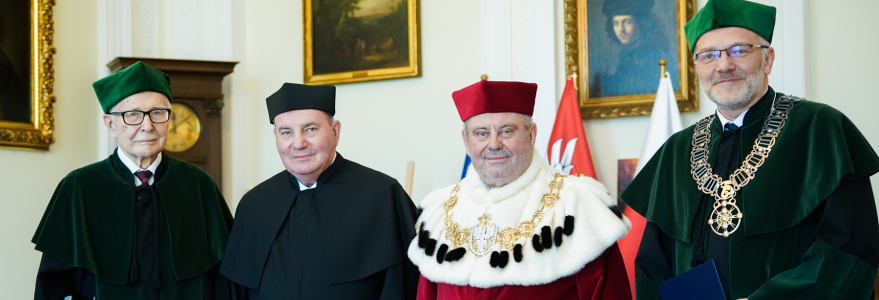 Four scholars, including Dr. Jacek Lipkowski, stand in regalia at formal award ceremony.