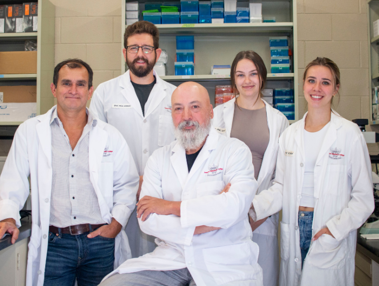 Five researchers standing in a lab.