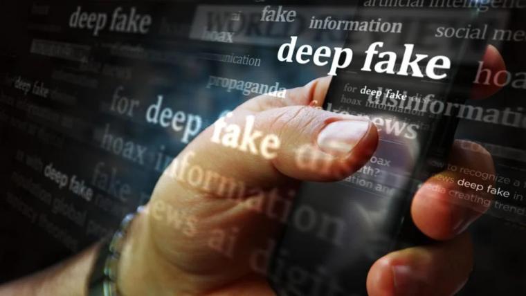A hand holding a mobile phone with the words "deep fake" appearing over the screen