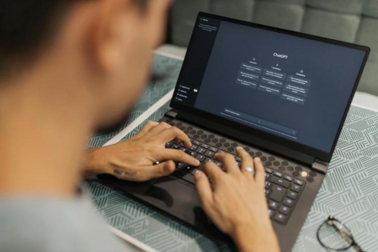 A person using an AI chatbot on a laptop.