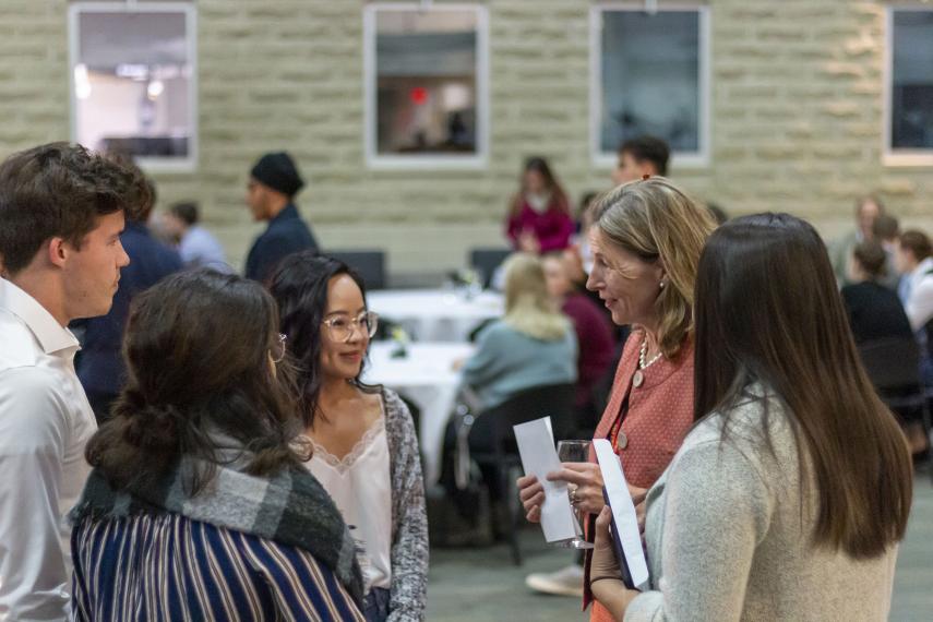 dean Wells speaking to group of students in Summerlee atrium