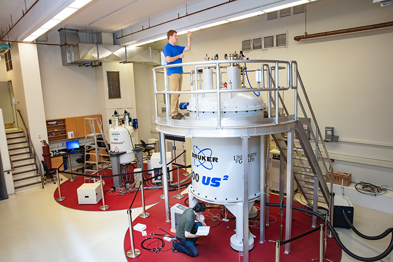 Image of two graduate students doing lab work in U of G's NMR facility
