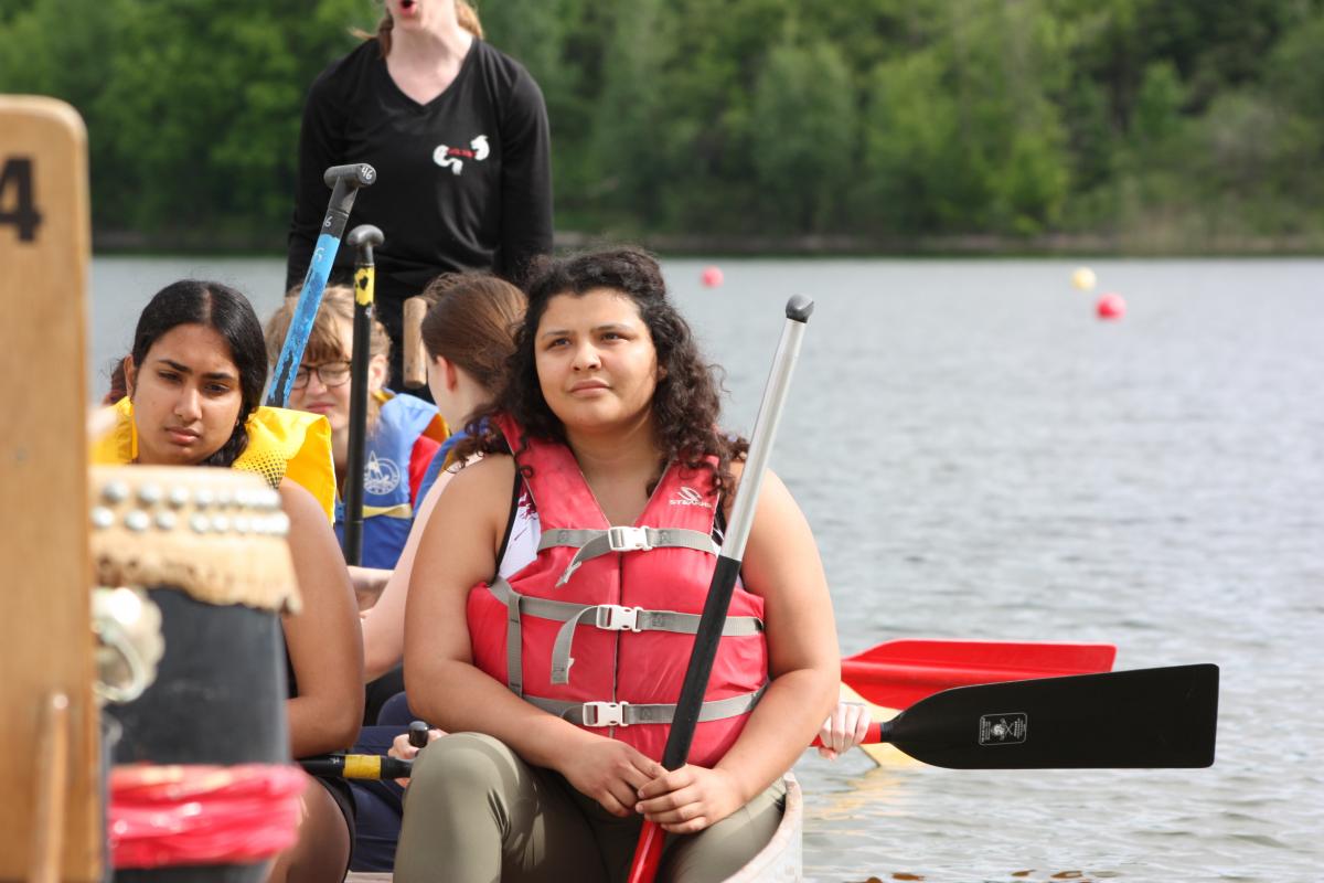 Gen Borg sits stationary in a dragonboat with several other people