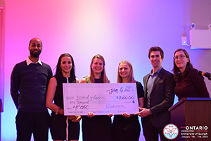 Second place winners in Consulting holding cheque