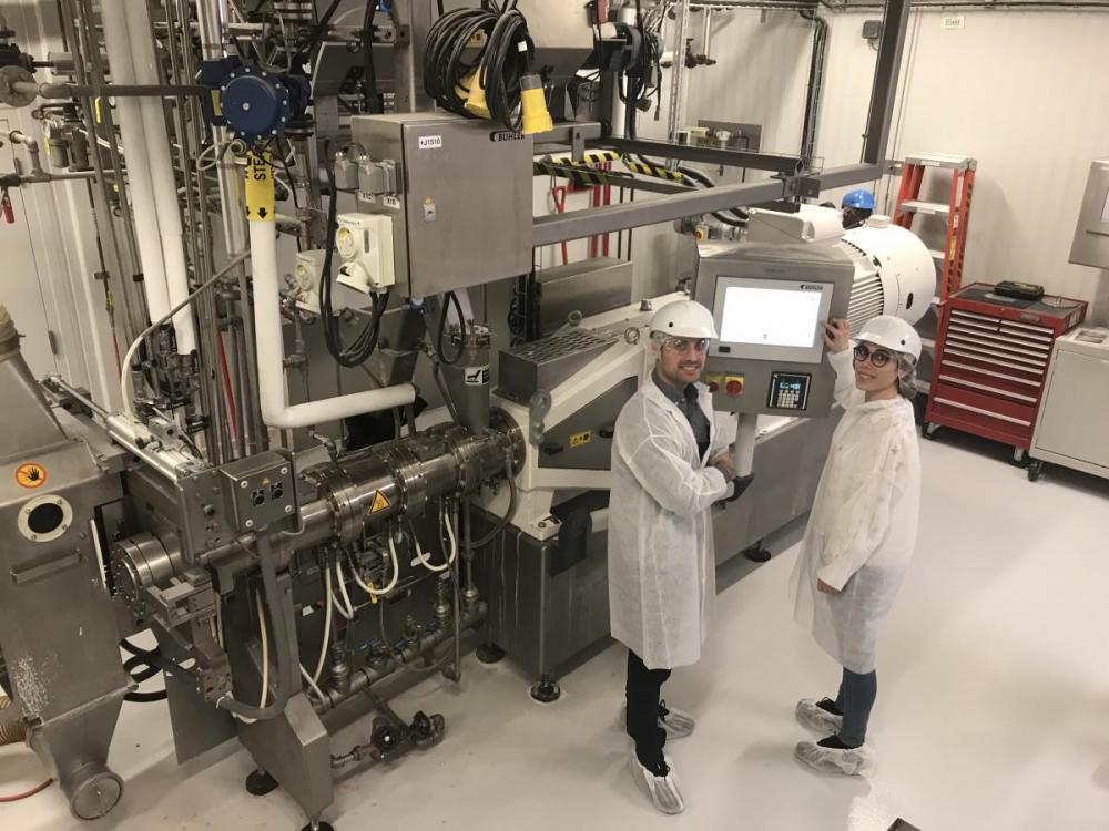 Prof. Martinez and Postdoc Laura Roman in front of large machinery