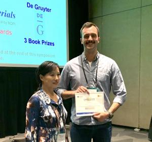 Joshua Van Der Zalm smiling with his award in his hand.